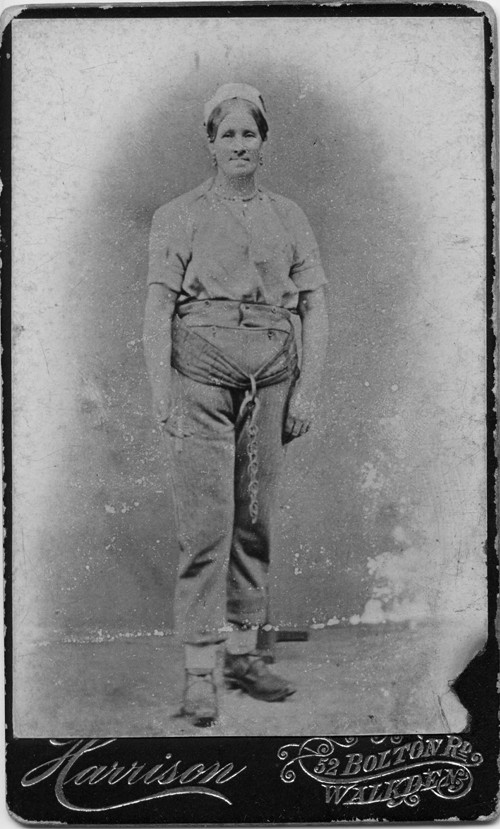 Late 19th century portrait photo of a woman worker in clogs and working clothes